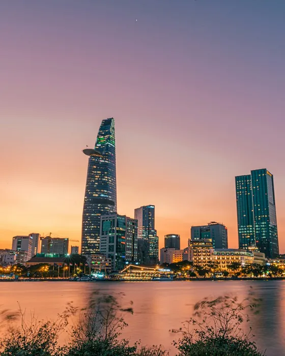 Ho Chi Minh City towers across the Saigon River at sunset